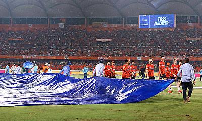 Groundsmen bring the rain covers as the IPL match between Gujrat Titans and Sunrisers Hyderabad