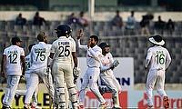 Bangladesh's cricketers celebrate after the dismissal of India's Cheteshwar Pujara (C) during the third day of the second Test match