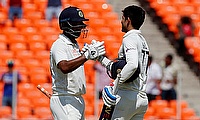 India's Shubman Gill celebrates with Cheteshwar Pujara after reaching his century