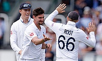 England's Josh Tongue celebrates with teammates after taking the wicket of Ireland's Fionn Hand