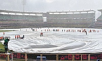 Covers are placed on the pitch as it rains during the ICC Men's Cricket World Cup