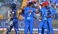 Afghanistan's Azmatullah Omarzai celebrates with teammates after the dismissal of Sri Lanka's Pathum Nissanka