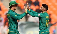 South Africa's Keshav Maharaj celebrates with teammate Rassie van der Dussen after taking the wicket of Afghanistan's Hashmatullah Shahidi