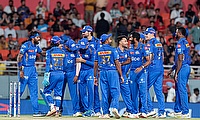 Mumbai Indians players celebrate the dismissal of Punjab Kings captain Sam Curran