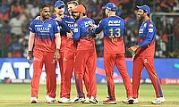 Royal Challengers Bengaluru players celebrate the wicket of Delhi Capitals' Abishek Porel