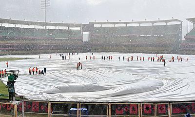 Covers are placed on the pitch as it rains during the ICC Men's Cricket World Cup