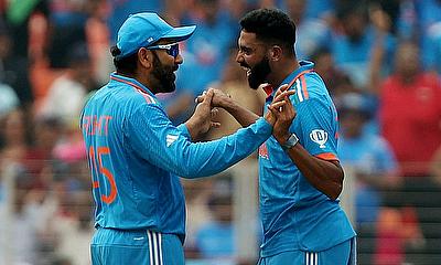 India's Mohammed Siraj celebrates with Rohit Sharma after taking the lbw wicket of Pakistan's Abdullah Shafique alt=