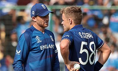 England's Sam Curran talks with team captain Jos Buttler alt=