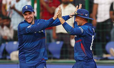England's Joe Root celebrates with Liam Livingstone after taking a catch to dismiss Afghanistan's Rashid Khan alt=