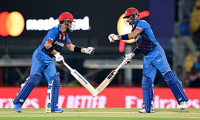 Afghanistan's Ibrahim Zadran and Rahmanullah Gurbaz bump fists during their innings alt=