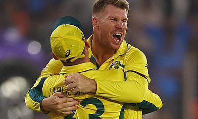Australia's David Warner celebrates with Marnus Labuschagne after taking the catch to dismiss England's Moeen Ali, off the bowling of Adam Zamp alt=