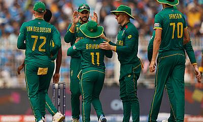 South Africa's Temba Bavuma celebrates with teammates after taking the catch to dismiss India's Rohit Sharma off the bowling of Kagiso Rabada alt=