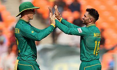 South Africa's Keshav Maharaj celebrates with teammate Rassie van der Dussen after taking the wicket of Afghanistan's Hashmatullah Shahidi