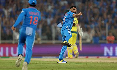 India's Mohammed Shami celebrates after taking the wicket of Australia's David Warner, caught out by Virat Kohli alt=