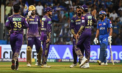 Kolkata Knight Riders players celebrate the wicket of Mumbai Indians' Naman Dhir