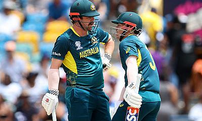 Australia's Travis Head and David Warner talk during play