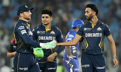 Gujarat Titans' Prasidh Krishna celebrates with Jos Buttler after taking the wicket of Mumbai Indians' Tilak Varma