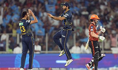 Gujarat Titans' Prasidh Krishna celebrates after taking the wicket of Sunrisers Hyderabad's Travis Head caught out by Gujarat Titans' Rashid Khan alt=