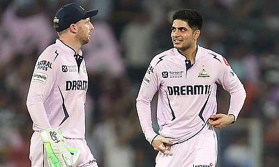 Gujarat Titans' Shubman Gill interacts with Jos Buttler