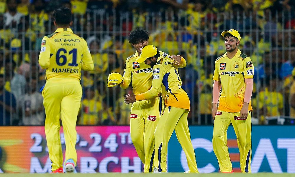 Chennai Super Kings' players celebrate the wicket of Royal Challengers Bengaluru's captain Faf du Plessis