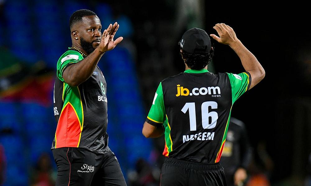 Kyle Mayers (L) of Saint Kitts and Nevis Patriots celebrates